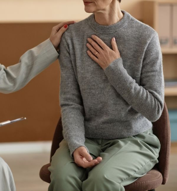Olive-Counselling-Individual-Counselling-Vancouver-British-Columbia Woman with hand over her heart in a therapy session